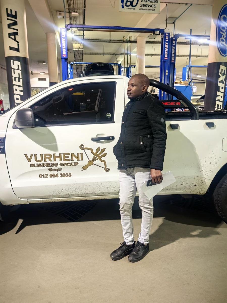 Vongani Boreni, Founder of Vacopi Logistics, beside a branded Vurheni Business Group vehicle