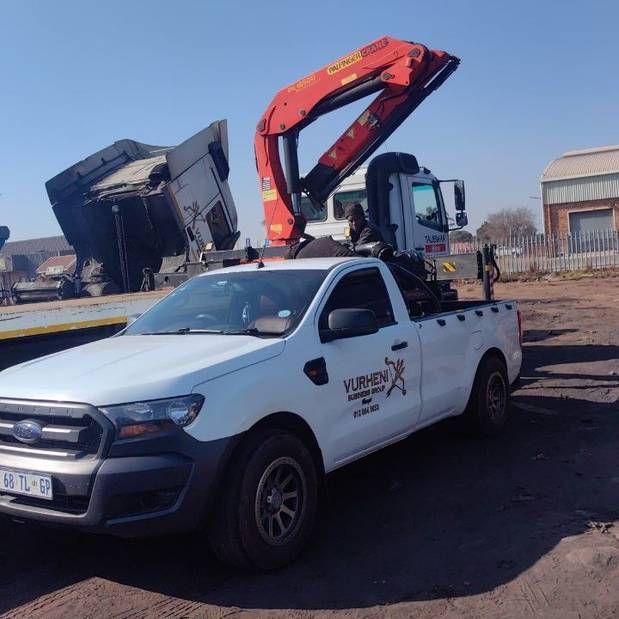 Vacopi operations team at an active loading site with crane and tipper trailer