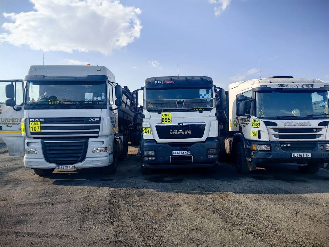 Three Vurheni Business Group trucks - DAF XF, MAN TGS and Scania P410 - lined up at a coal yard in Mpumalanga
